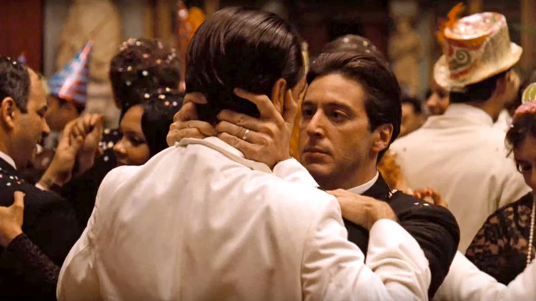 Michael Corleone (Al Pacino) kisses Fredo Corleone (John Cazale) at a party in The Godfather Part II