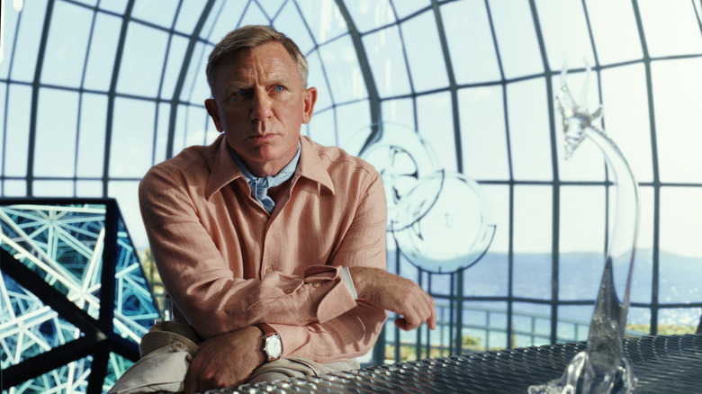Daniel Craig as Benoit Blanc in Glass Onion sitting down