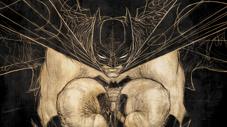 Batman crouches on a ledge