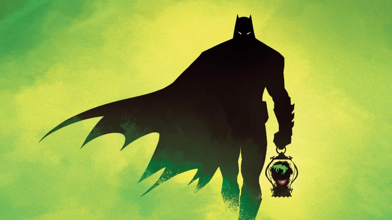 Batman marches through a green fog with the Joker's head in a lantern