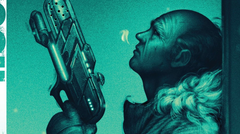 Leonard Snart leans against a wall with his gun
