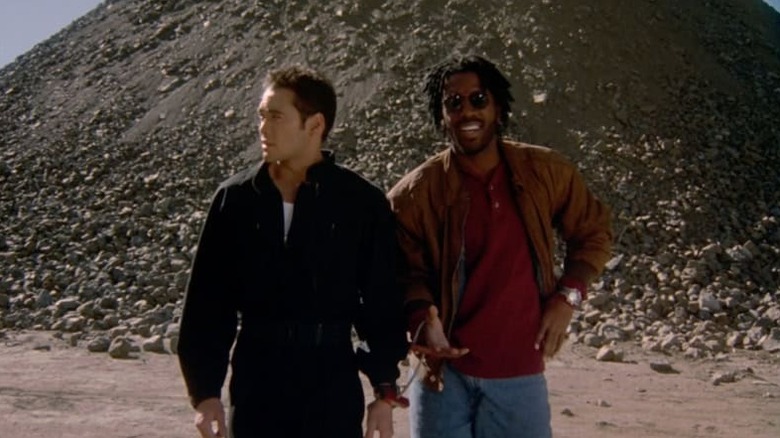 Mark Dacascos as Toby and Kadeem Hardison as Malik walking through quarry in Drive