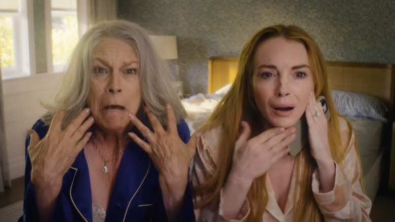 Jamie Lee Curtis as Lily trapped in Tess' body and Lindsday Lohan as Harper trapped in Anna's body looking at themselves in the mirror in Freakier Friday