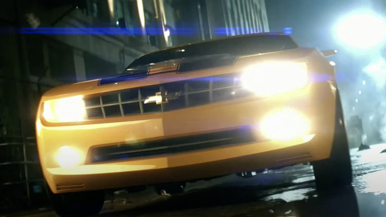 A 2007 Chevrolet Camaro's headlights shine in the night in Transformers (2007)