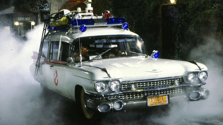 The Ecto-1 emerges from smoke in Ghostbusters (1984)