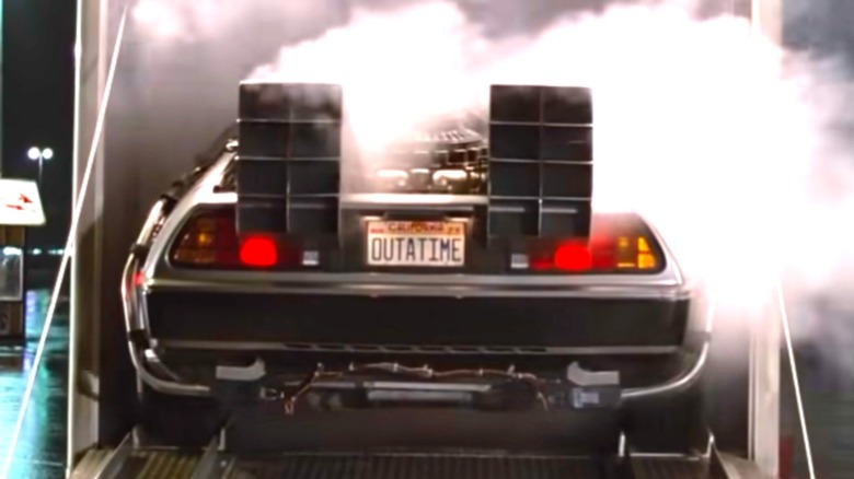 The DeLorean backs out of a truck in Back to the Future