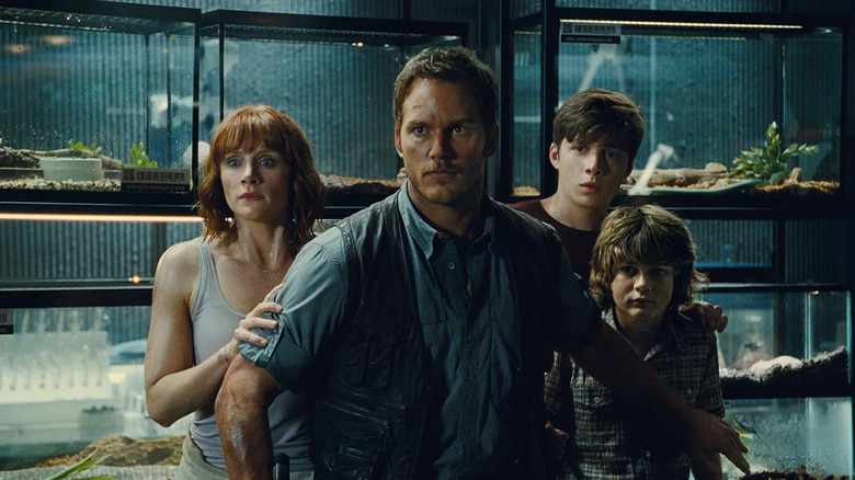 Owen protecting Claire, Gray, and Zach in Jurassic World