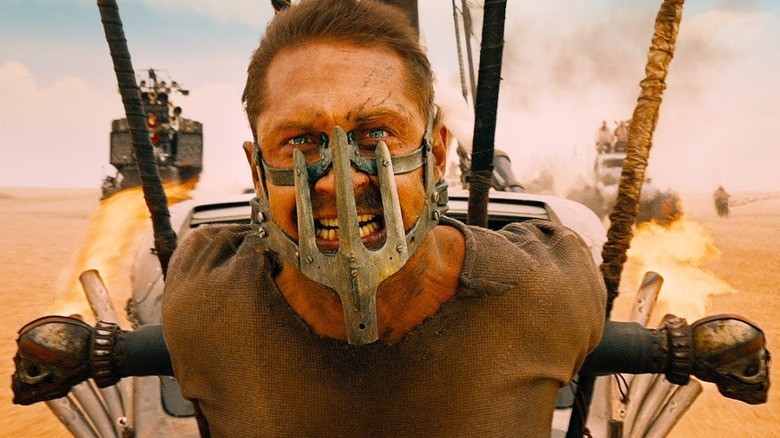 Tom Hardy as Max, strapped to the front of a car, in Mad Max: Fury Road