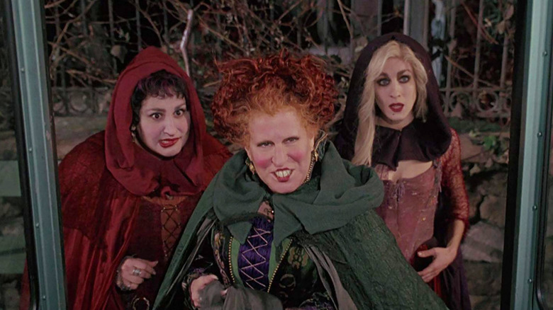 Bette Midler, Sarah Jessica Parker, and Kathy Najimy as the Sanderson sisters waiting to board the bus in Hocus Pocus