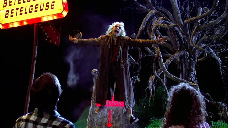 Betelgeuse (Michael Keaton) rises triumphantly from his grave in Beetlejuice