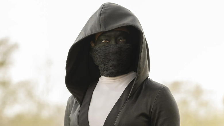 Regina King stares into the distance as Sister Night in Watchmen