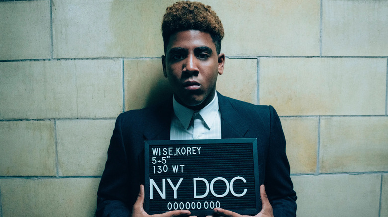 Jharell Jerome as Korey Wise, taking a mug shot in When They See Us.