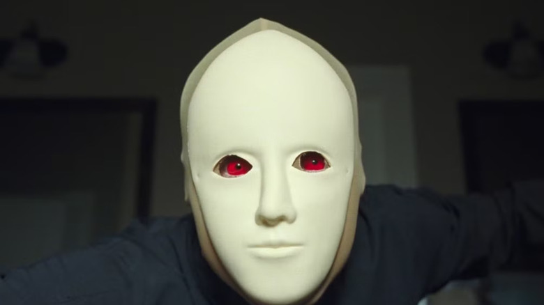 Arthur wearing red contacts and a mask in Faces of Death