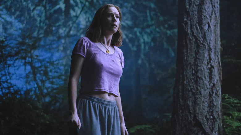 Kris in her pajamas in a forest at night in Teenage Sex and Death at Camp Miasma