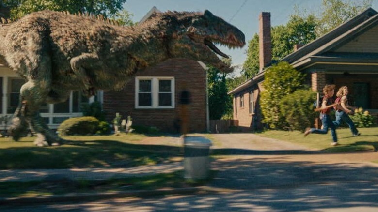 An allosaurus chasing after Aubrey and Brian in The End of Oak Street