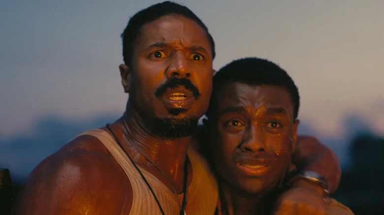 Michael B. Jordan and Miles Caton as Smoke and Sammie Moore, hugging each other in fear in Sinners