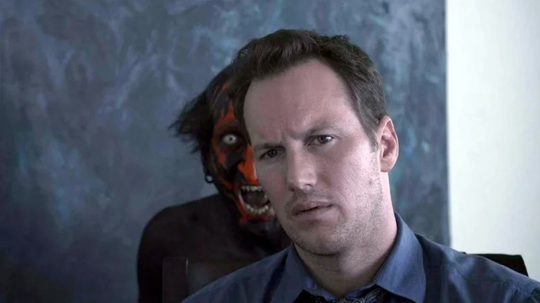 A demon standing behind Patrick Wilson's Josh Lambert in Insidious