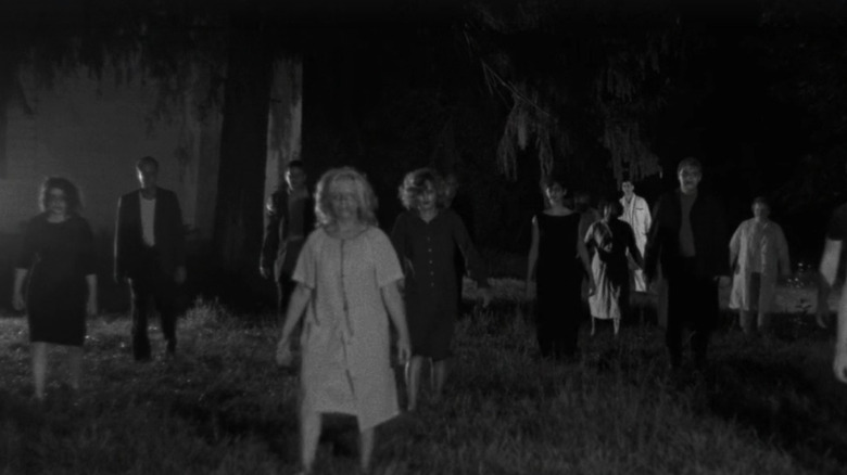 Zombies walking across lawn in Night of the Living Dead