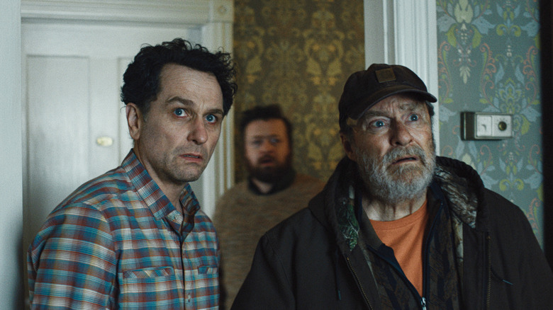 Tom Loftis (Matthew Rhys), Kurt (Neil Casey), and Wyck (Stephen Root) peer fearfully at something in Widow's Bay