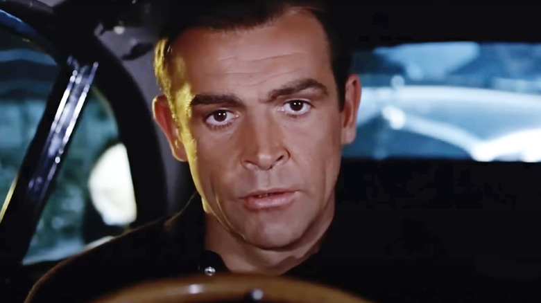 Sean Connery as James Bond in his Aston Martin in Goldfinger