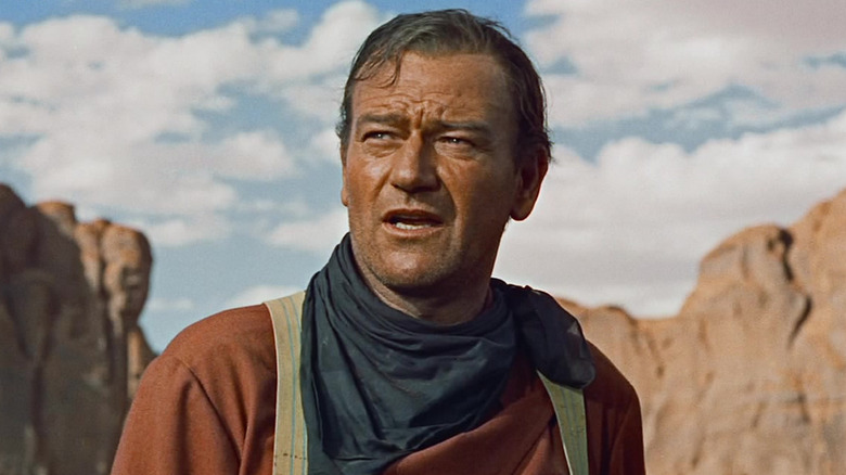John Wayne as Ethan Edwards looking distrusting in The Searchers