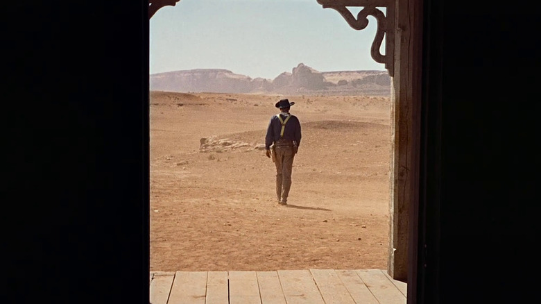 John Wayne as Ethan Edwards framed in a doorway in The Searchers