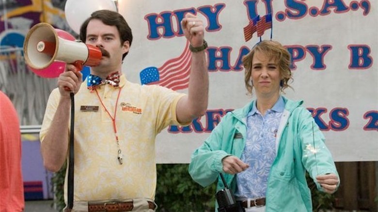 Kristen Wiig standing next to Bill Hader with microphone in Adventureland