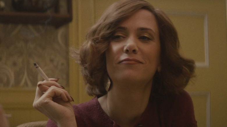 Kristen Wiig smirking and smoking a cigarette in Diary of a Teenage Girl