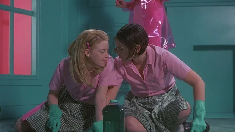 Natasha Lyonne as Megan and Clea DuVall as Graham cleaning while wearing pink in But I'm A Cheerleader