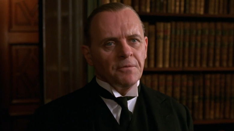 James Stevens (Anthony Hopkins) stands looking expectantly in The Remains of the Day