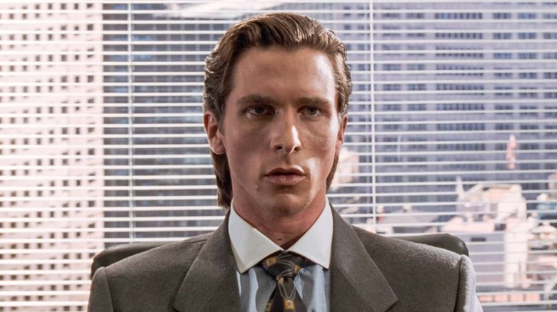 Patrick Bateman (Christian Bale) sits impassively in his office in American Psycho