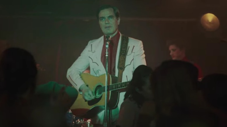 George plays guitar on stage