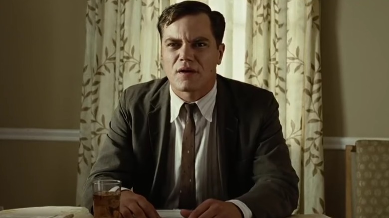 John Givings scowling at the dinner table