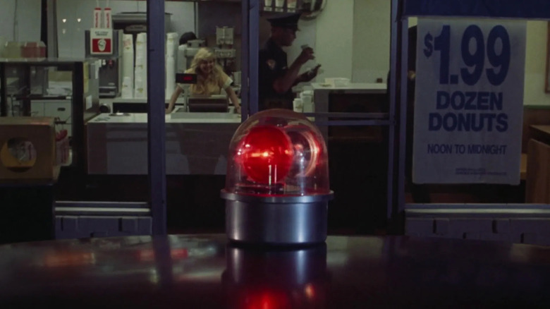 Cop car at donut shop in The Naked Gun opening title sequence