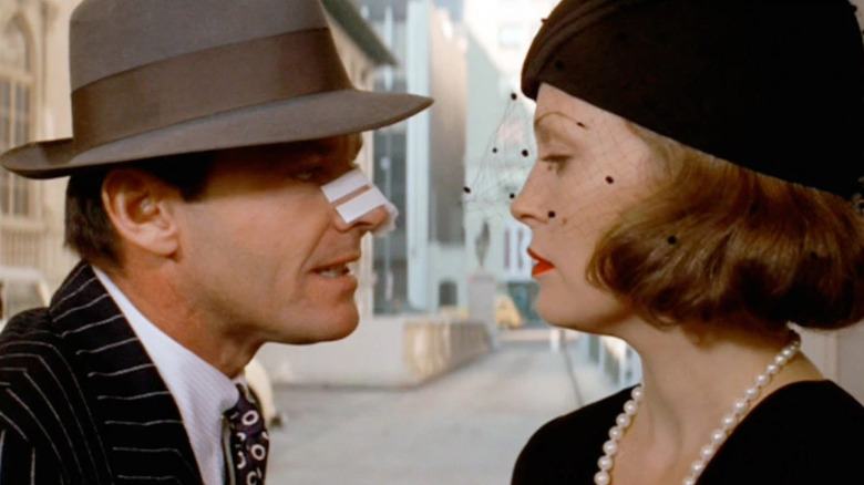 Jack Nicholson with bandaged nose as Gittes and Faye Dunaway in hat as Evelyn in Chinatown
