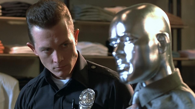 Robert Patrick's T-1000 looking at a silver mannequin in Terminator 2: Judgment Day