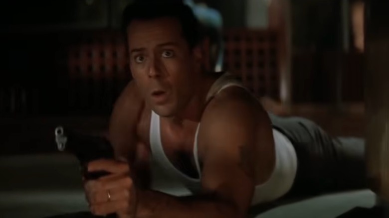 John McClane (Bruce Willis) crawling on the floor in Die Hard