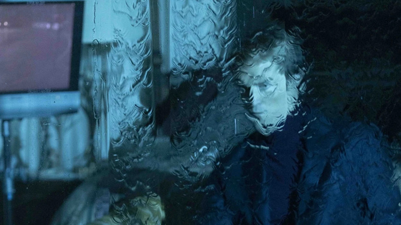 Chris Hansen obscured by rain on a window in Primetime