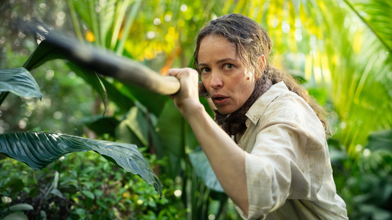 Rachel McAdams as Linda Liddle standing in the middle of a jungle and holding a makeshift spear in Send Help
