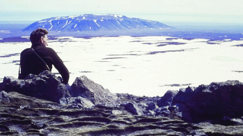Someone sitting on a mountain in Time and Water