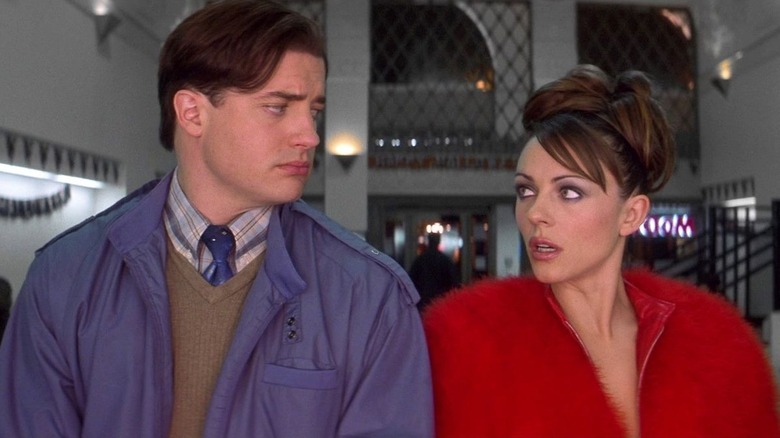 Brendan Fraser as Elliot Richards and Elizabeth Hurley as the Devil, looking at each other in Bedazzled (2000).