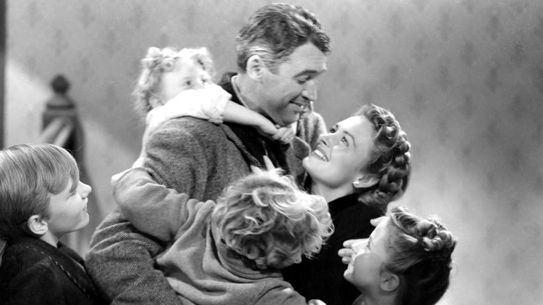 James Stewart as George Bailey, surrounded by his family in It's A Wonderful Life.