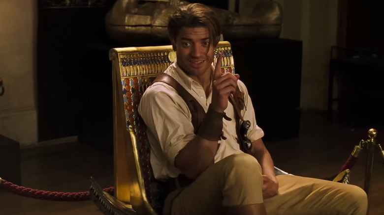 Brendan Fraser as Rick O'Connell, sitting in a golden chair in The Mummy (1999)