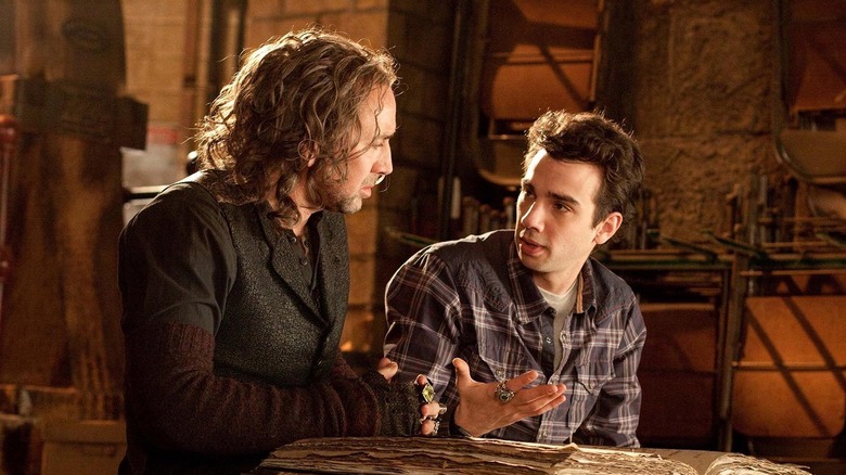 Nicolas Cage as Balthazar Blake and Jay Baruchel as Dave Stutler, speaking to one another in The Sorcerer's Apprentice