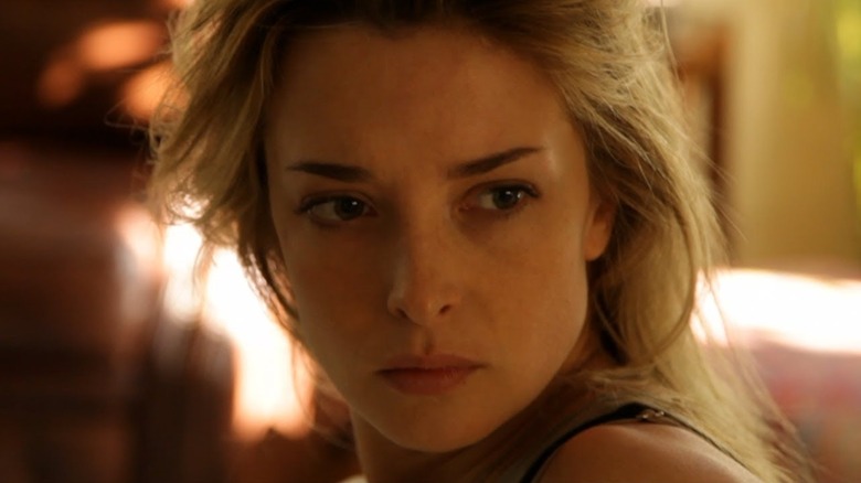 Emily (Emily Baldoni) glances concerned over her shoulder in Coherence