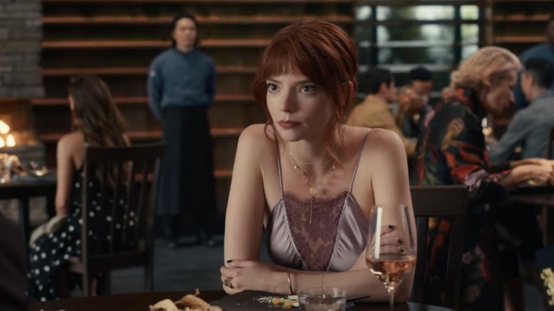 Margot (Anya Taylor-Joy) stares intently at a dinner table in The Menu (2022)