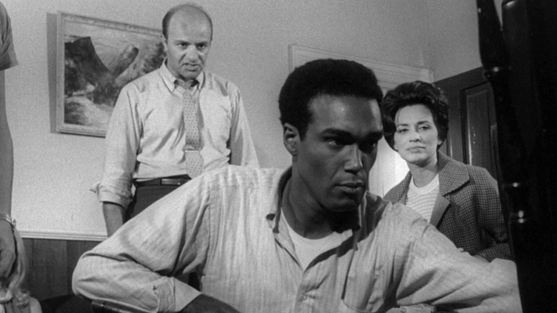 Harry Cooper (Karl Hardman), Ben (Duane Jones), and Helen Cooper (Marilyn Eastman) reckon with zombies and each other in Night of the Living Dead