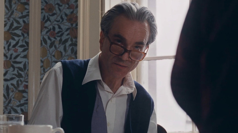Daniel Day Lewis as Reynolds Woodcock looking up over his glasses in Phantom Thread