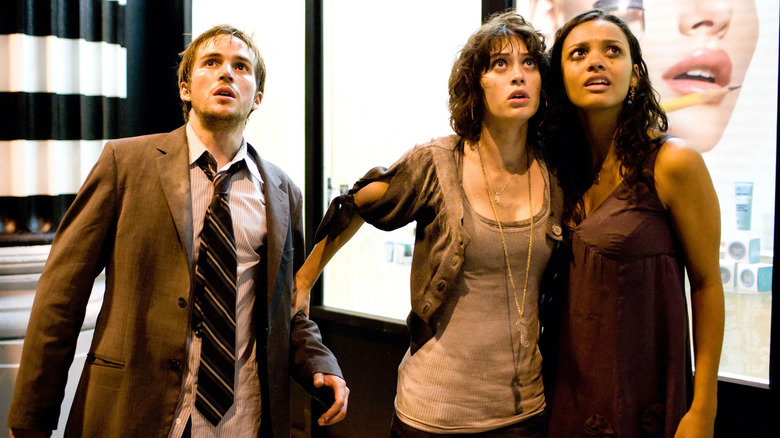 Michael Stahl-David as Robert stands next to Lizzy Caplan as Marlena and Jessica Lucas as Lily in Cloverfield