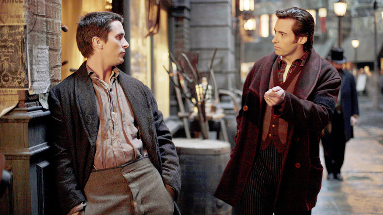 Christian Bale and Hugh Jackman as Alfred Borden and Robert Angier, meeting in the street in The Prestige